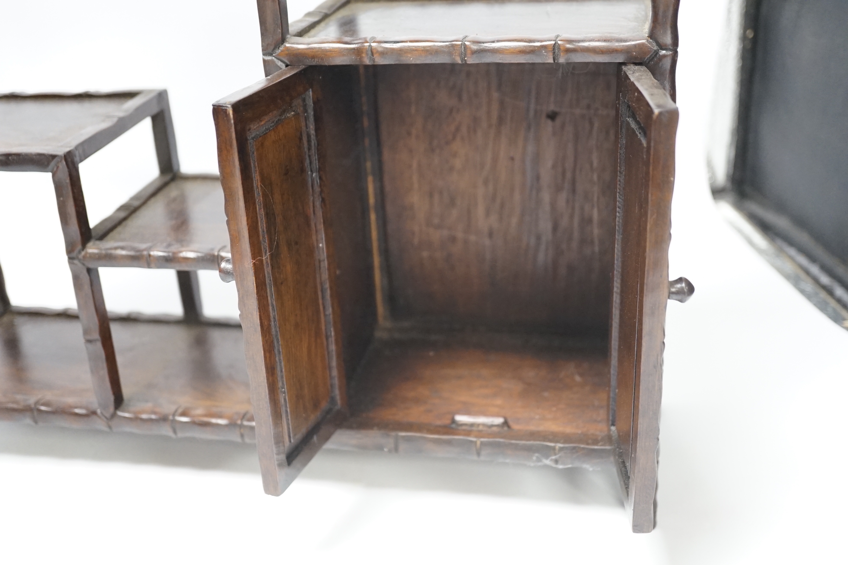 An early 20th century Chinese hongmu display shelf with cupboard and drawer, 46cm high